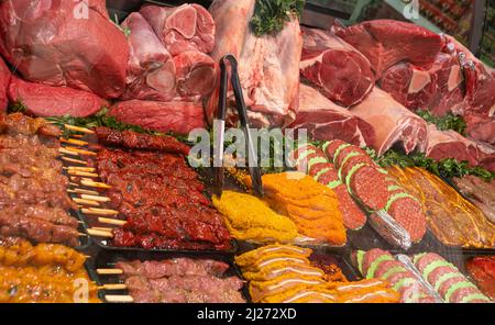Showcase with a variety of raw meat Dishes. Stock Photo