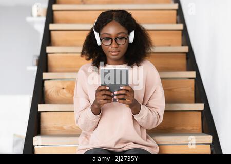 African American Student Lady Using Digital Tablet At Home Stock Photo
