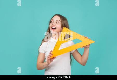 cheerful child with math triangle measuring tool Stock Photo