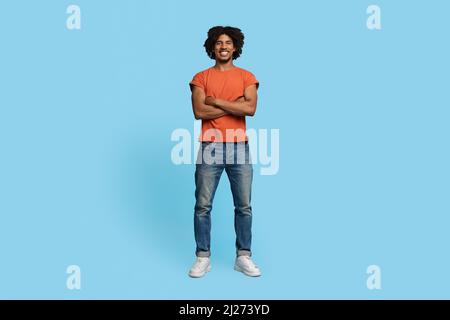 Confident stylish african american guy posing on blue Stock Photo