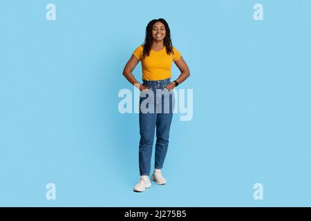Pretty stylish african american woman posing on blue Stock Photo