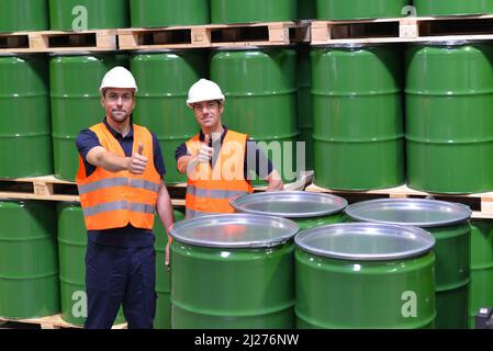 group of workers in the logistics industry work in a warehouse with chemicals Stock Photo