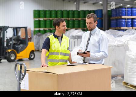 group of manager and worker in the logistics industry work in a warehouse with chemicals Stock Photo