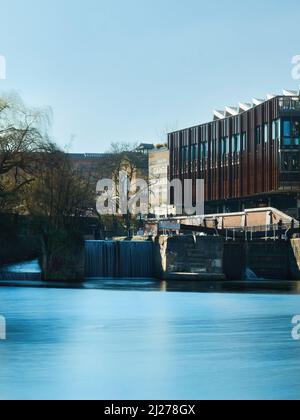 A long exposure view across Grand Union Canal at Hawley Lock to the recently re-developed Hawley Wharf section of Camden Market. Stock Photo