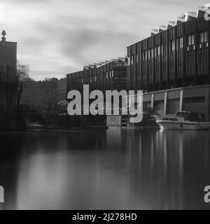 A long exposure view across Grand Union Canal at Hawley Lock to the recently re-developed Hawley Wharf section of Camden Market. Stock Photo