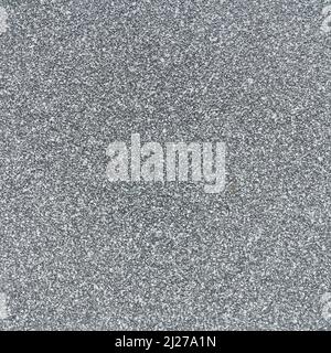 Gray granite stone surface. Grainy gray-white texture. Grey melange marl background. Textured abstract background or wallpaper. Stock Photo