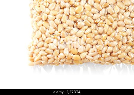 Kernels of peeled pine nuts in vacuum packaging on a white background Stock Photo