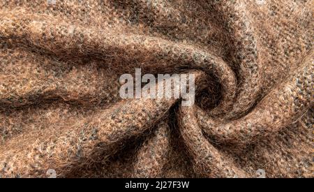 Twisted brown lambswool fabric with waves and curves. Wool material. felt texture Stock Photo