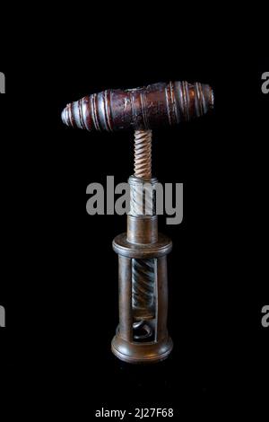 Antique vintage corkscrew on black background Stock Photo