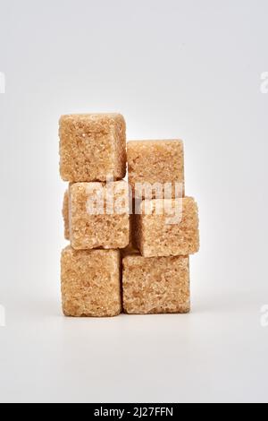 Brown sugar cubes isolated on white background, closeup shot Stock Photo