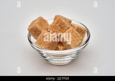 Brown sugar cubes isolated on white background, closeup shot Stock Photo