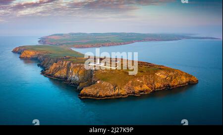 Aerial view at sunrise of Mull of Galloway Lighthouse at southern most point in Scotland, in Dumfries and Galloway, Scotland, UK Stock Photo