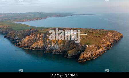 Aerial view at sunrise of Mull of Galloway Lighthouse at southern most point in Scotland, in Dumfries and Galloway, Scotland, UK Stock Photo