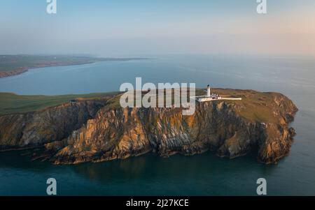 Aerial view at sunrise of Mull of Galloway Lighthouse at southern most point in Scotland, in Dumfries and Galloway, Scotland, UK Stock Photo