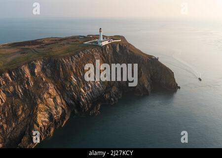 Aerial view at sunrise of Mull of Galloway Lighthouse at southern most point in Scotland, in Dumfries and Galloway, Scotland, UK Stock Photo