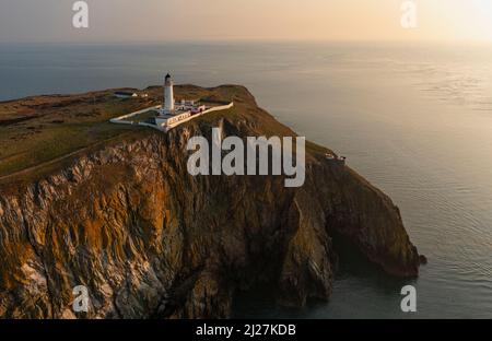 Aerial view at sunrise of Mull of Galloway Lighthouse at southern most point in Scotland, in Dumfries and Galloway, Scotland, UK Stock Photo