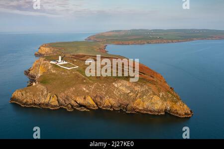 Aerial view at sunrise of Mull of Galloway Lighthouse at southern most point in Scotland, in Dumfries and Galloway, Scotland, UK Stock Photo