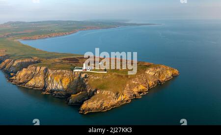 Aerial view at sunrise of Mull of Galloway Lighthouse at southern most point in Scotland, in Dumfries and Galloway, Scotland, UK Stock Photo