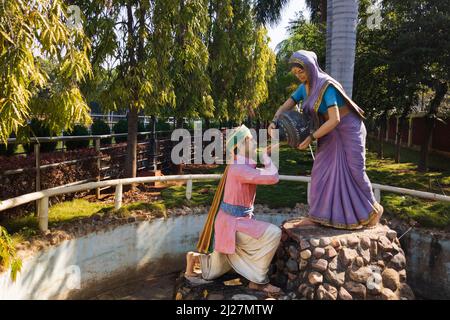 Beautiful shot of Indian traditional dressed men and women cement sculptures in Almatti Rock garden: Almatti-Bagalkot, Karnataka, India-January 31.202 Stock Photo