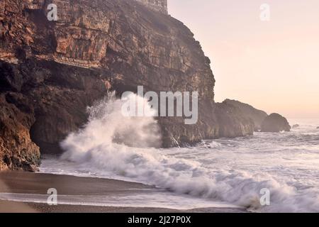 Praia do Norte (north beach) waves crashing on the cliff in Nazare Portugal. Stock Photo