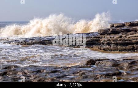 Waves breaking over Jurassic rocks at Nash Point on the Glamorgan Heritage Caost in South Wales UK Stock Photo