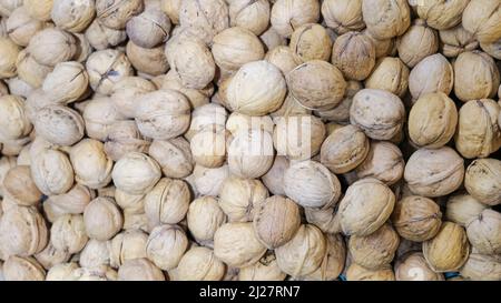 mountain of walnuts on a supermarket shelf. Stock Photo