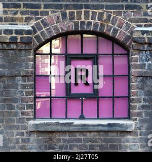 Coal Drops Yard - individual letters in coloured glass windows in old warehouse Stock Photo