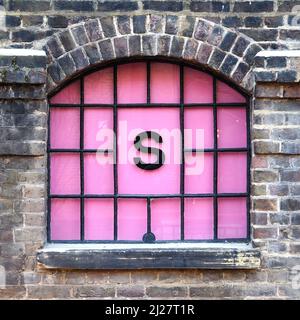Coal Drops Yard - individual letters in coloured glass windows in old warehouse Stock Photo