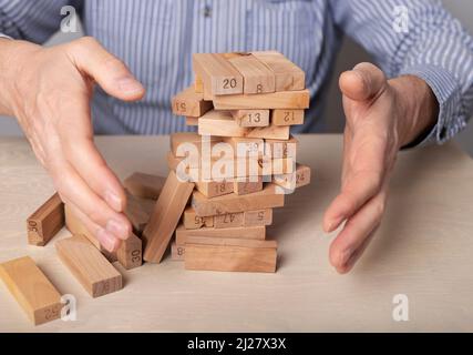 Business crisis concept with wood blocks falling down. High quality photo Stock Photo