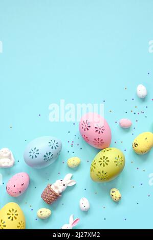 Easter composition. Easter eggs and easter bunny on pastel blue background. Minimal concept of Easter. Flat lay, top view, copy space Stock Photo