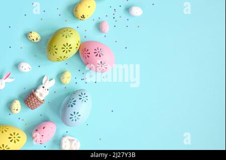 Easter composition. Easter eggs and easter bunny on pastel blue background. Minimal concept of Easter. Flat lay, top view, copy space Stock Photo