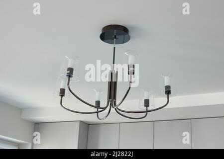 Chandelier with many light bulbs on the ceiling Stock Photo