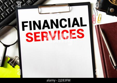Man hand writing word financial services, business concept Stock Photo