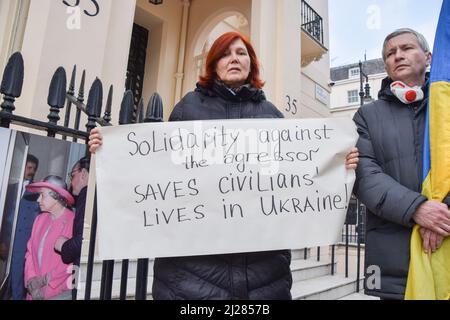 London, UK. 30th March 2022. Demonstrators gathered outside the Embassy of Hungary in protest against Prime Minister Viktor Orban's neutral stance towards the war in Ukraine and refusal to support Ukraine. Protesters left shoes and lit candles outside the embassy to commemorate those killed by Russian troops. Credit: Vuk Valcic/Alamy Live News Stock Photo