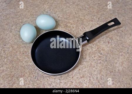 Mini frying pan and two blue chicken eggs Stock Photo