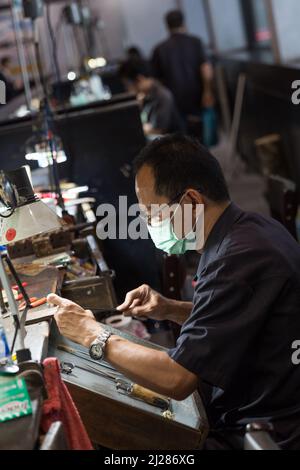 Thai Jeweler making fine Jewelry in a workshop Stock Photo