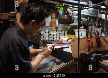 Thai Jeweler making fine Jewelry in a workshop Stock Photo