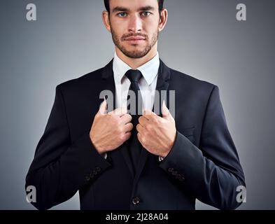 The difference between ordinary and extraordinary is that little extra. Studio portrait of a handsome young businessman dressed in a suit against a Stock Photo