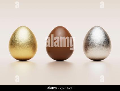 Milk chocolate easter eggs with gold and silver Aluminium foil on pale background. Stock Photo