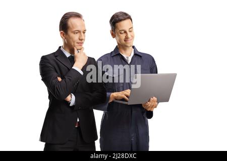 Businessman and a worker in a uniform looking at a digital tablet isolated on white background Stock Photo