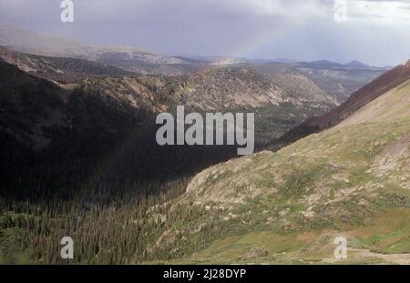 CO: Grand County, Arapahoe National Forest, Rollins Pass Road, following the Transcontinental Railroad View east over the Indian Peaks, with a rainbow Stock Photo