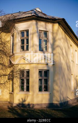 old yellow two-storey house in sunny weather Stock Photo