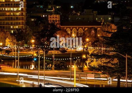 A long exposure shot of headlights and car trails of the city in the night Stock Photo