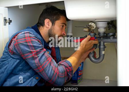 I think I see your problem. Shot of a plumber fixing a pipe. Stock Photo