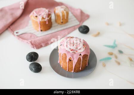 Easter cake, colorful eggs and willow branches on light background. Happy Easter holiday concept. festive spring season Stock Photo