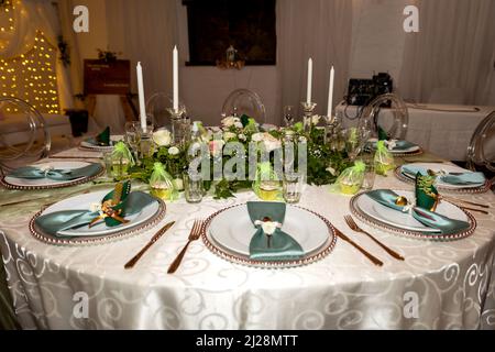 Green and Gold Theme Table setting and decorations Stock Photo