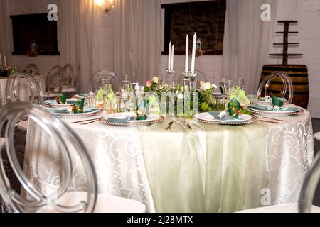 Green and Gold Theme Table setting and decorations Stock Photo