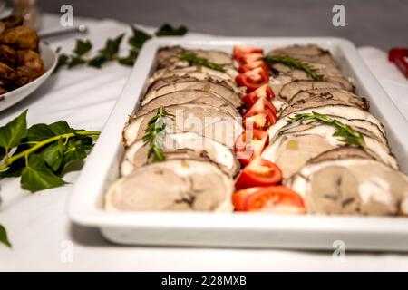 Roasted meat cold cut slices on a white platter Stock Photo