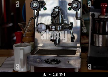 Closeup of espresso machine and hand tamper Stock Photo