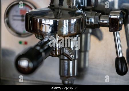 Closeup of espresso machine and hand tamper Stock Photo